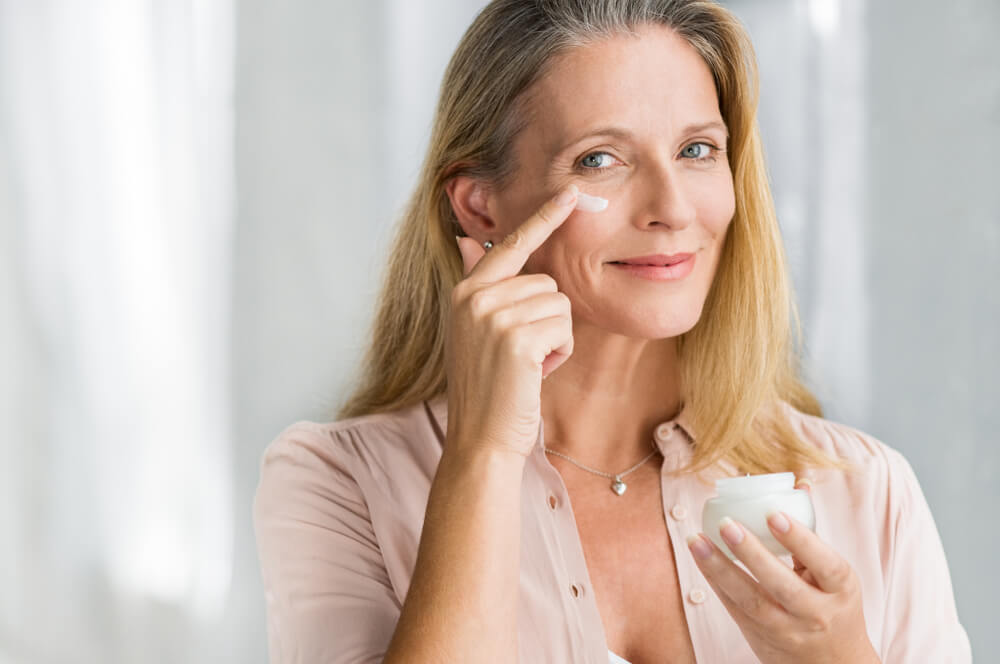 Woman applying eye cream