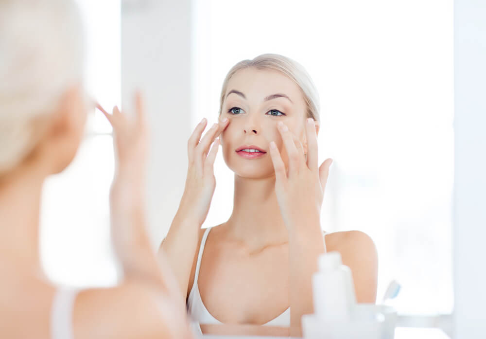 Woman applying Lavelier Eye Firming Concentrate