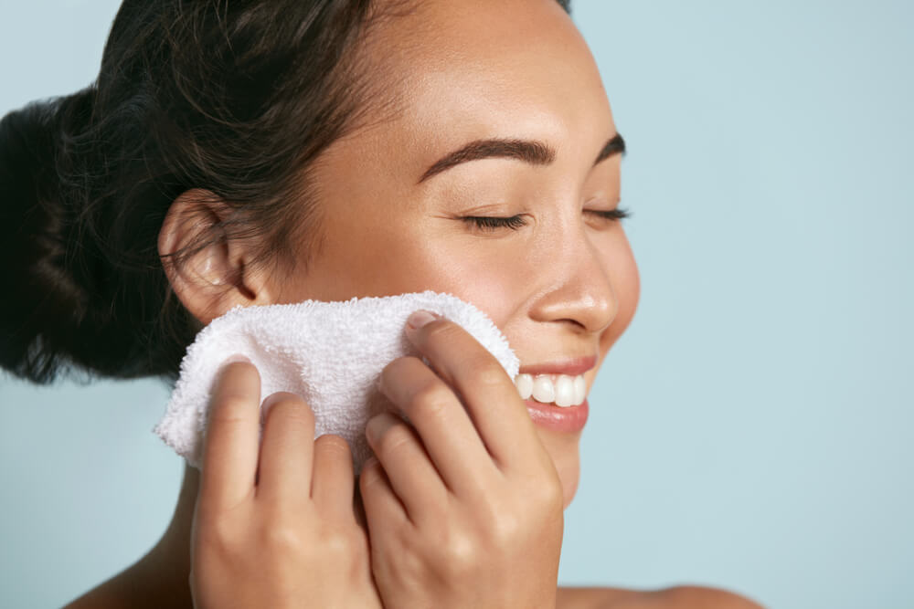 Woman wiping clean face