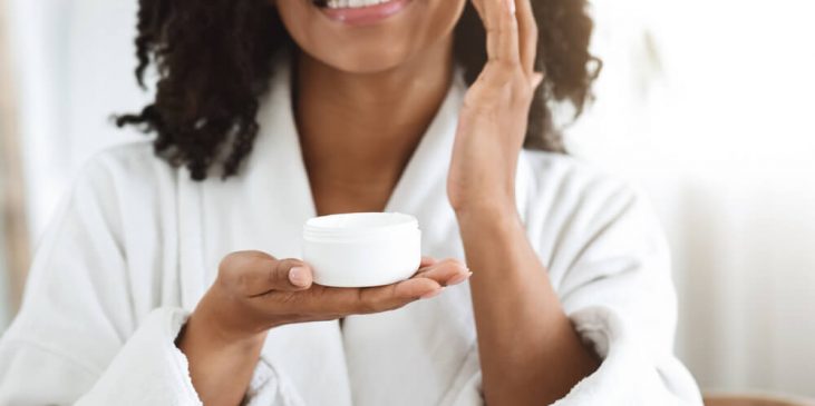 Woman applying face cream - anti aging ingredients