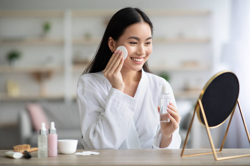 Woman applying skincare product