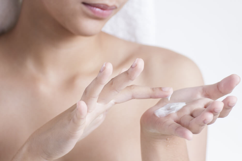 Woman applying face cream