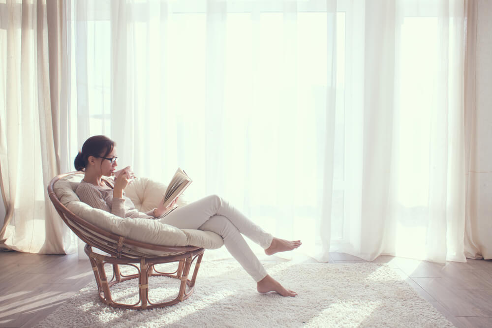 Woman reading to de-stress for your skin