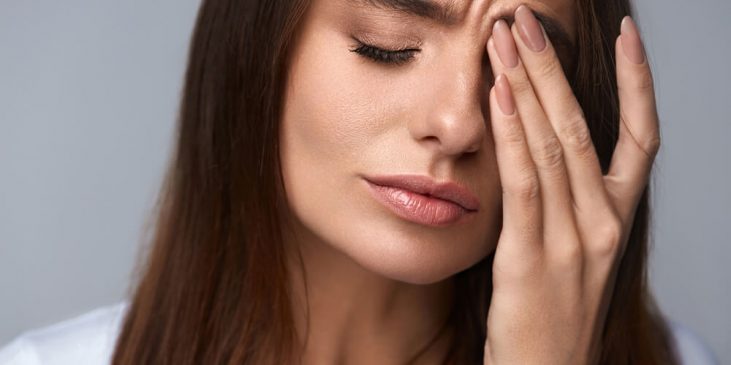Woman rubbing face - De-stress Skin Care Products