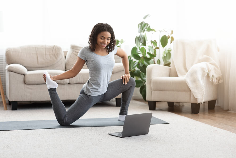 Woman doing yoga at home - stay active