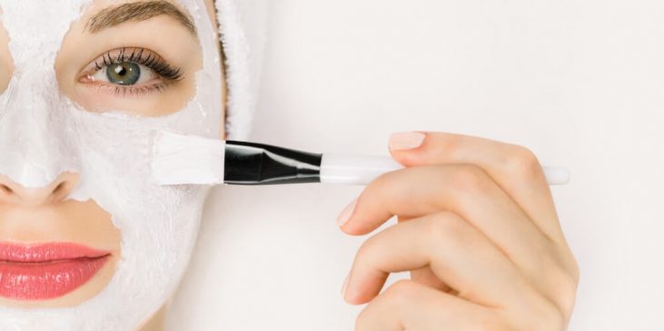 Woman applying hydrating face mask