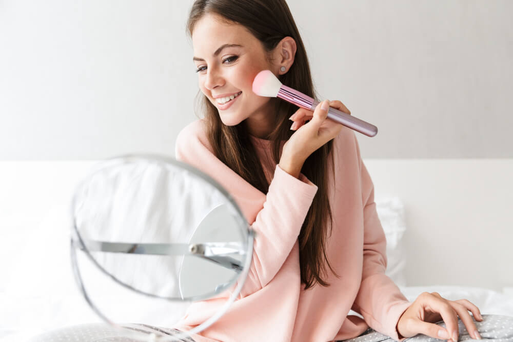 Woman applying makeup