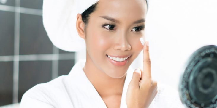 Woman applying face cream