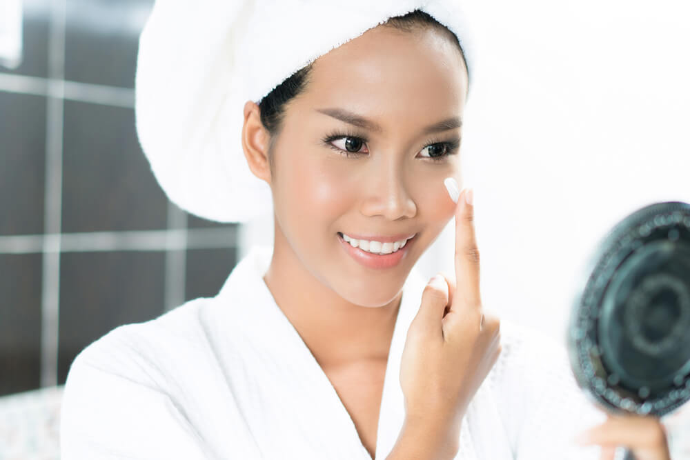 Woman applying face cream