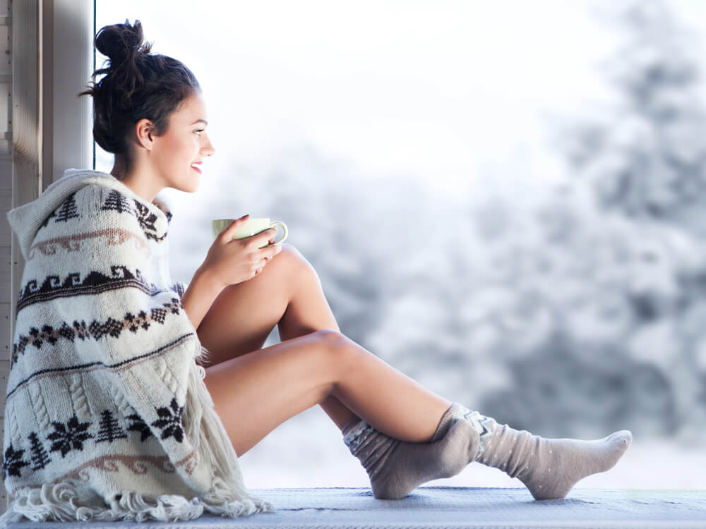 Woman in winter thinking of new year's resolutions for your skin