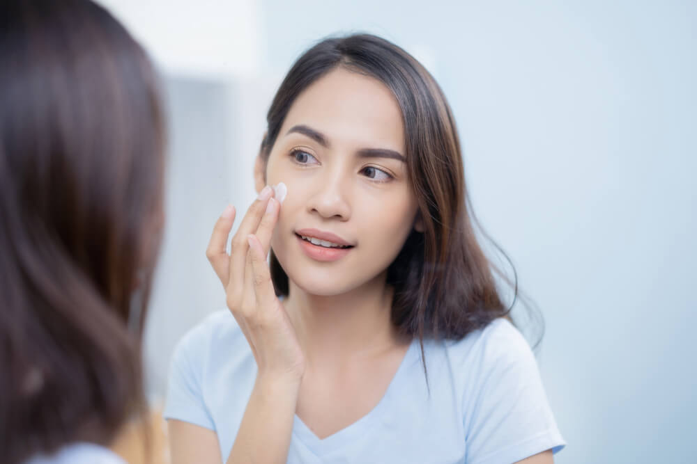 Woman applying face cream