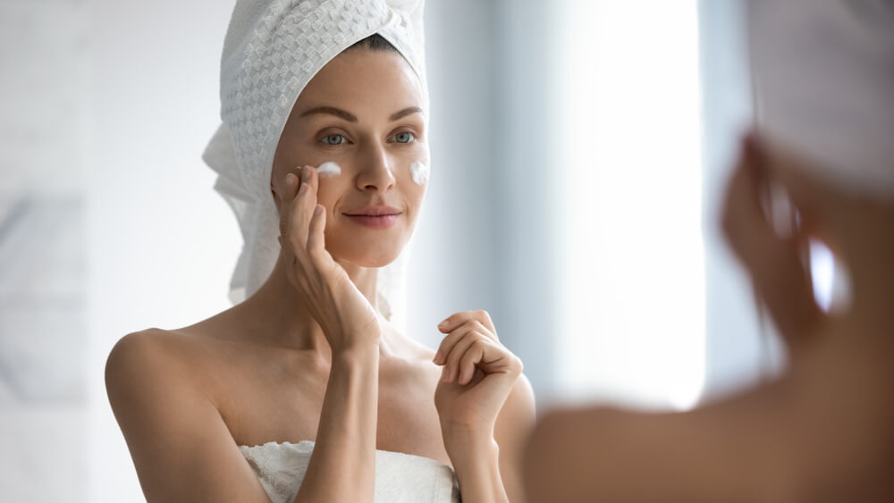 Woman applying face cream