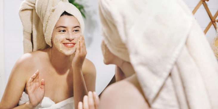 Woman applying face mask - skintellectual