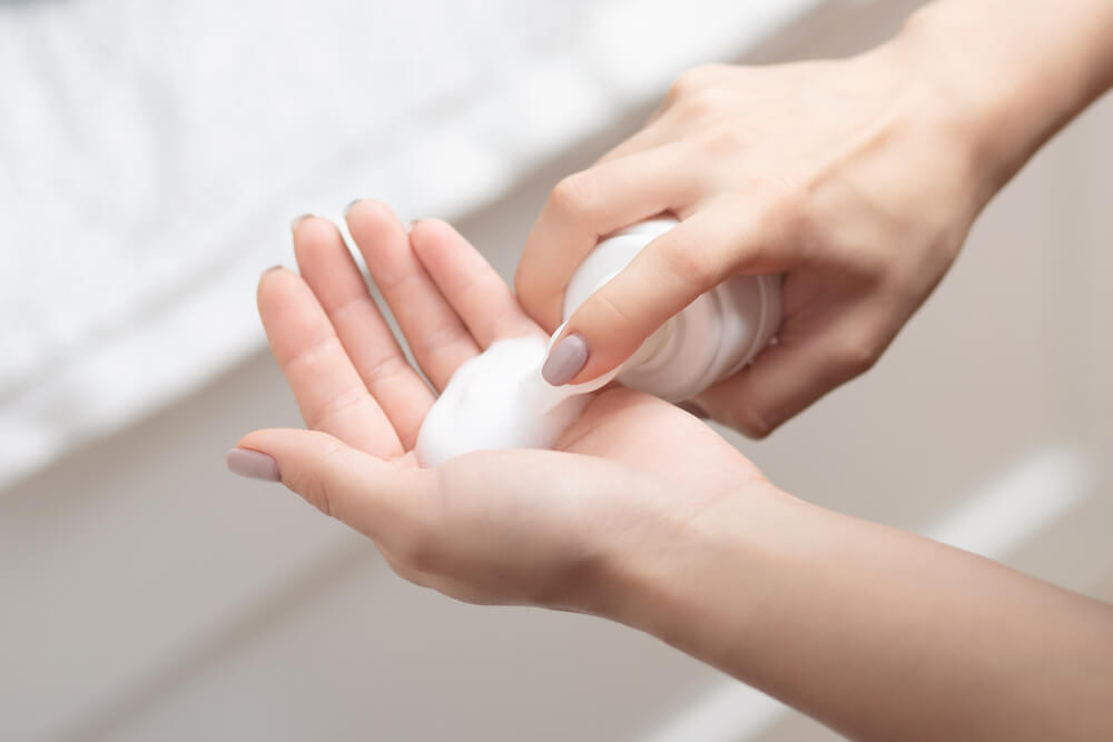 Woman applying cleanser to hand