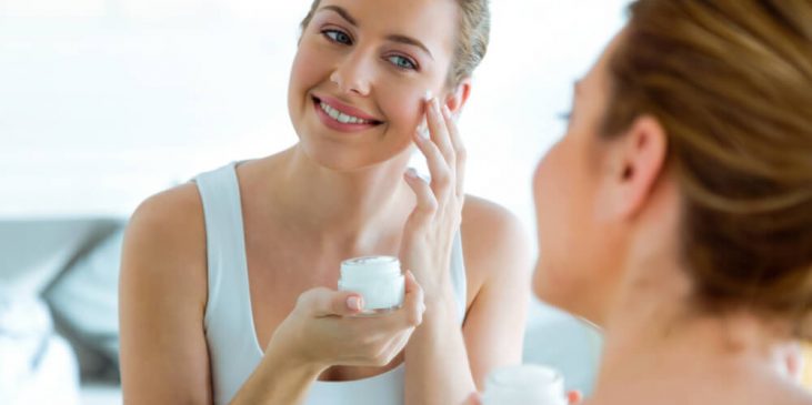 Woman applying face cream