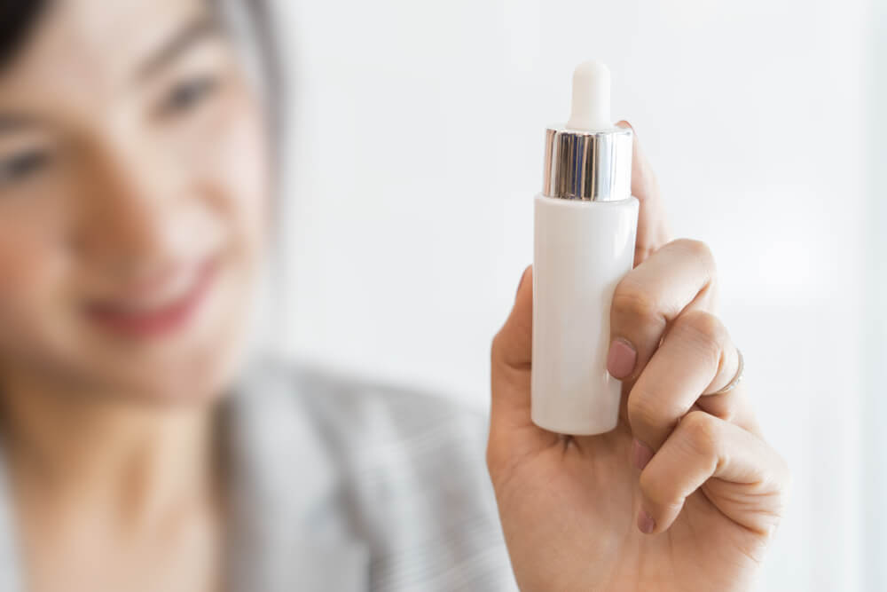 Woman holding serum bottle