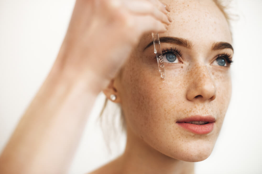 Woman applying serum