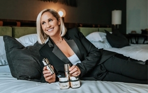 Woman laying on bed with lavelier products