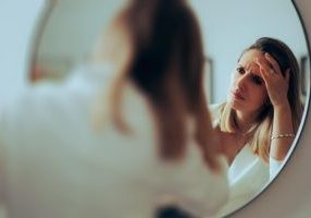 woman mirror skincare