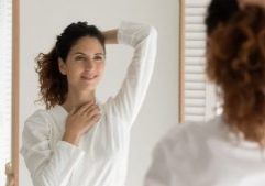 woman looking in mirror