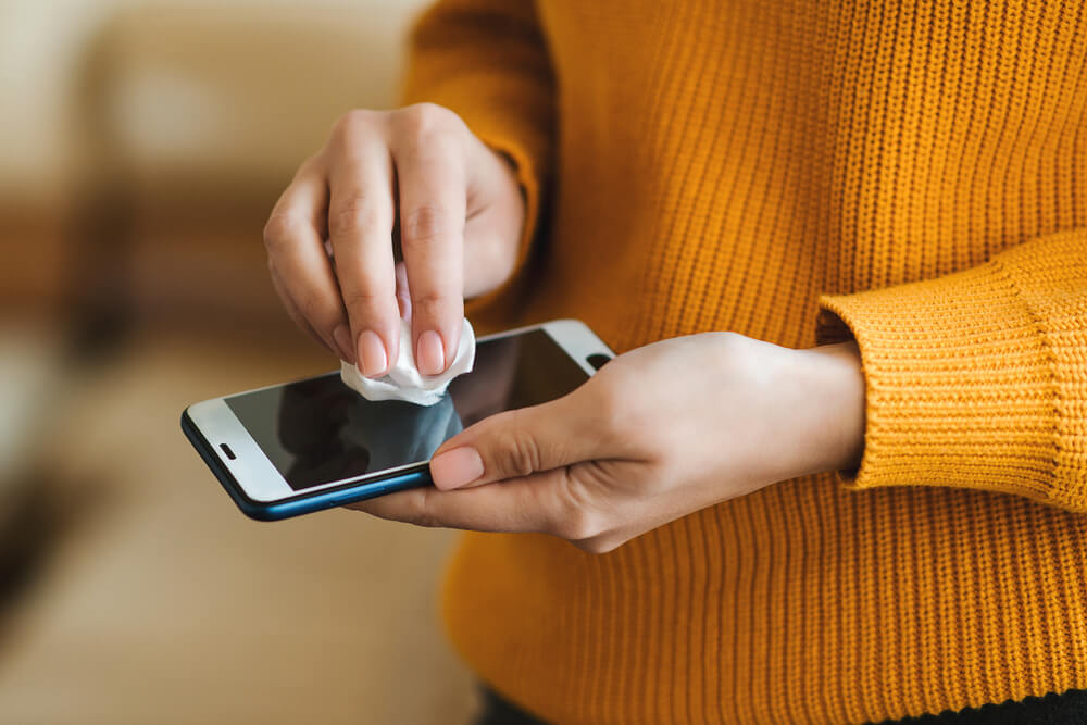 person cleaning phone