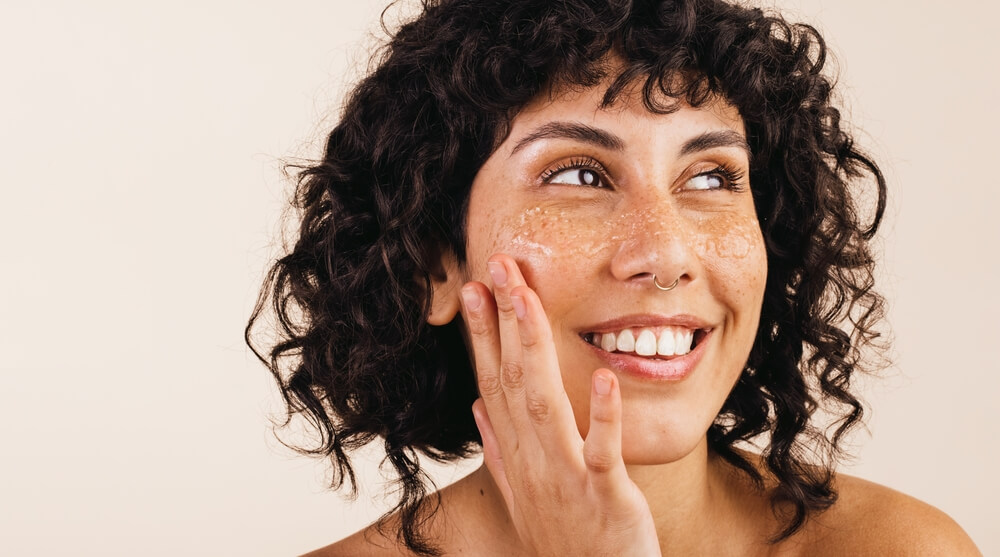 smiling woman exfoliating