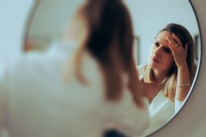 woman mirror skincare
