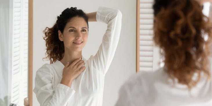 woman looking in mirror